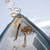 prow of boat on frozen lake with ice hole and snowshoes