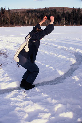 steward dancing around a circular path with fugure attached to her back