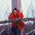 tourangeau in red against a background of bare trees