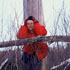 woman in red jacket by a tree